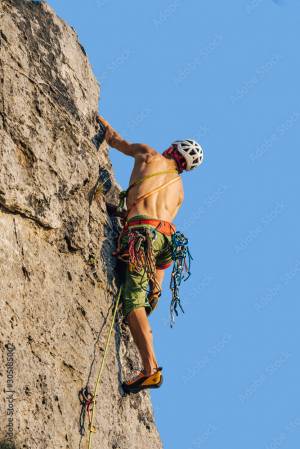 Climber climbing on a rock face